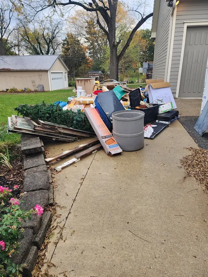 Dumpster being loaded with debris for Estate Cleanout Dumpster Rental in Dunbar